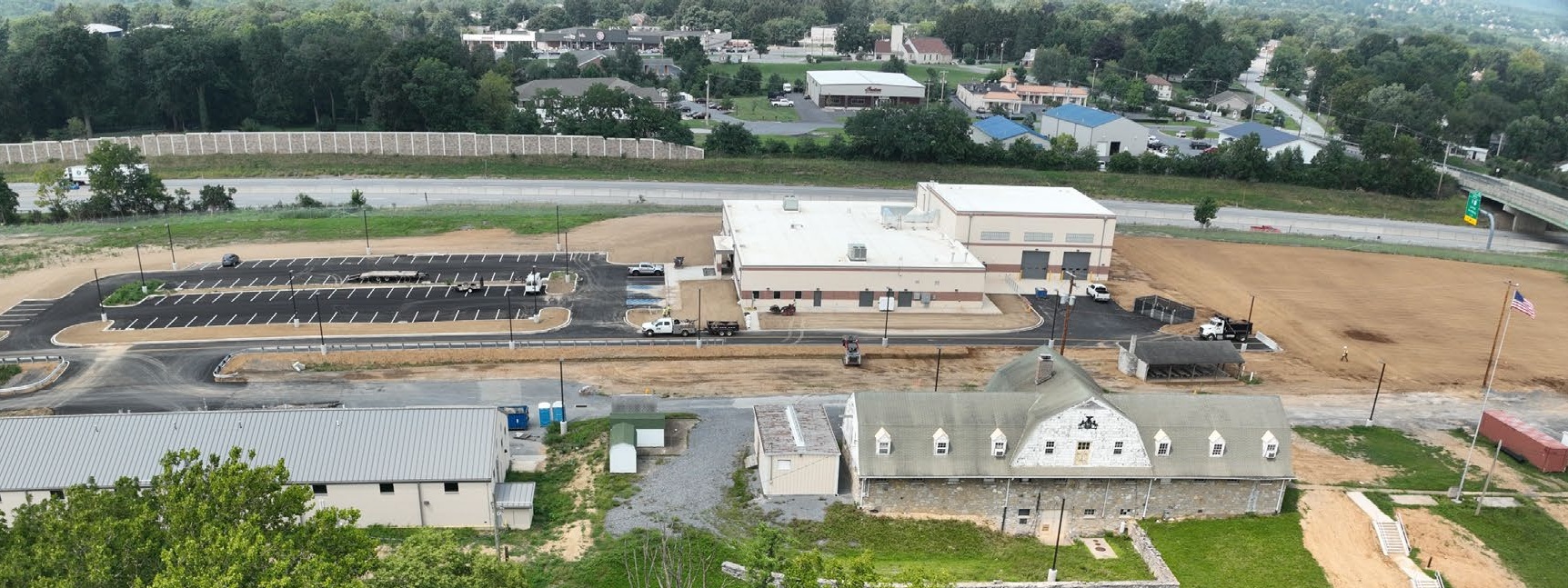 Aerial view of buildings, parking, and greenery. Aerial view of buildings, parking, and greenery.