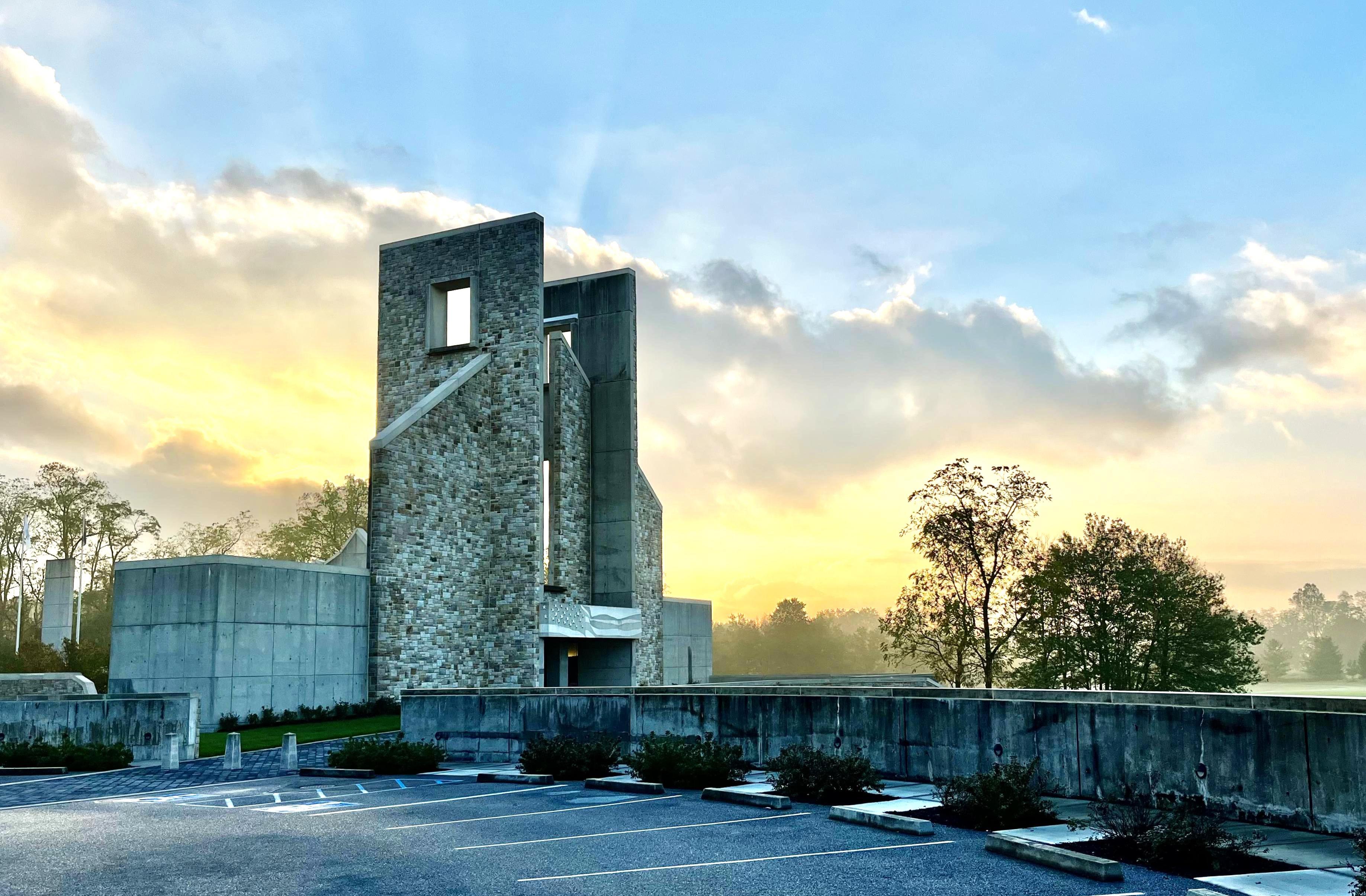 Stone building at sunrise with empty parking lot